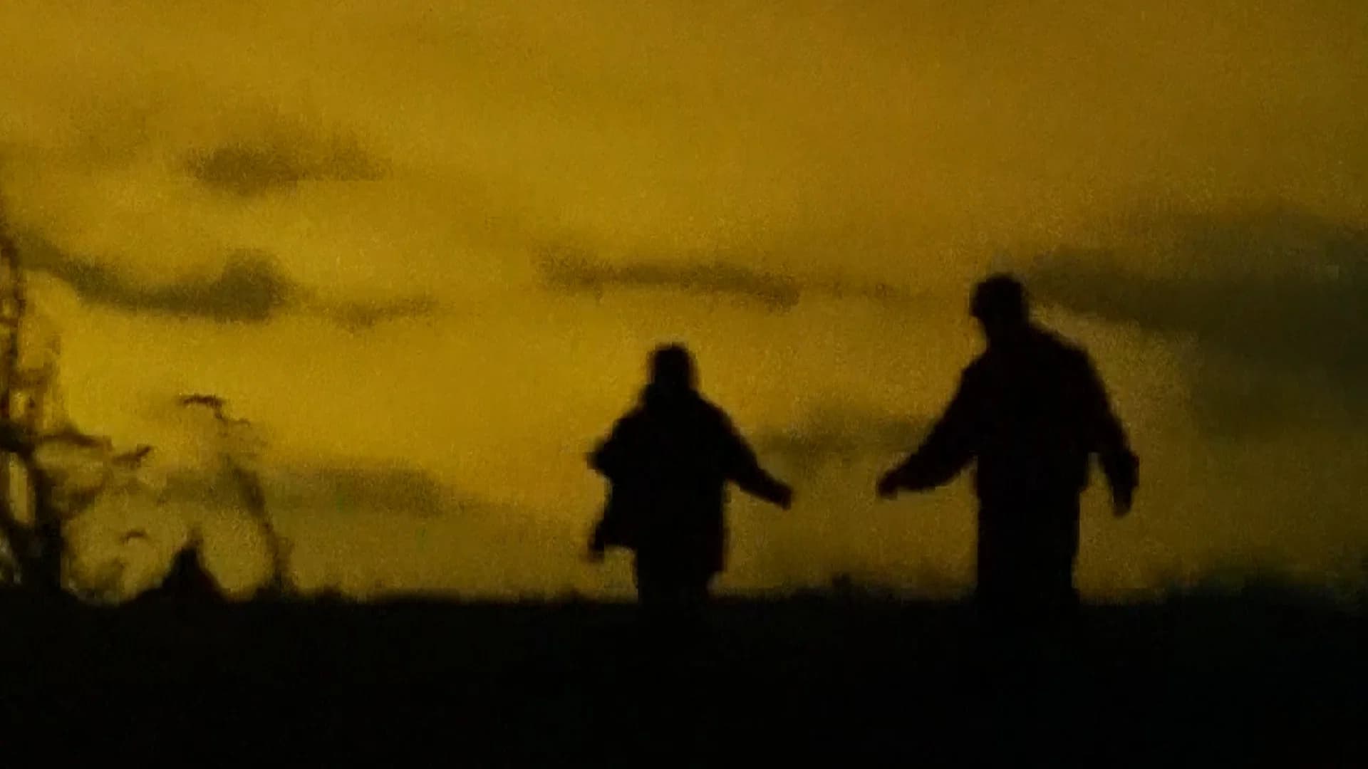 Figures Around a Fire